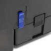 A close-up view of a black plastic device with a blue lever switch and a textured black panel. Podgląd zdjęcia produktu
