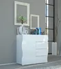 A modern white highboard sideboard with drawers is placed against a gray wall, decorated with framed pictures and a vase with branches. A large window with black mullions is visible in the background. Voir les images du produit
