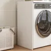 A laundry basket and a washing machine are shown in a bathroom or laundry room setting. Podgląd zdjęcia produktu
