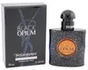Yves Saint Laurent Black Opium Eau de Parfum Intense, schwarzer glitzernder Flakon mit kupferfarbenem Etikett und schwarzer Box mit blauen Glitzerdetails. Náhled obrázku produktu