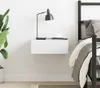 A bedside scene with a floating nightstand, a lamp, a cup, and a bed. Anteprima dell’immagine prodotto