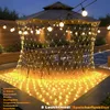 An outdoor patio area at night, decorated with string lights. Náhled obrázku produktu