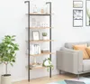 A ladder shelf with decorative items and plants placed in a room next to a sofa. Produktbild-Vorschau