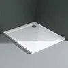 A white square shower tray with a drain hole is shown in a bathroom setting with dark gray tiled walls and light gray tiled floor. Produktbild-Vorschau