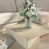 A close-up of a modern living room with a beige couch and a travertine coffee table. Náhled obrázku produktu