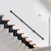 A modern staircase with a black metal handrail and wooden steps against a white wall. Náhled obrázku produktu