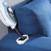 A steam cleaner is being used to clean a blue fabric couch. Náhled obrázku produktu