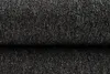 A close-up view of a dark gray, textured fabric, likely a rug or carpet, folded over itself. Produktbild-Vorschau