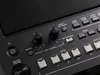 A close-up view of the control panel of a Yamaha PSR-SX 600 keyboard, showing various buttons, knobs, and a speaker grille. Anteprima dell’immagine prodotto