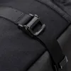 A close-up view of a black buckle and strap on a black fabric bag. Produktbild-Vorschau