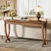 A long, narrow wooden console table with a lamp and books on it, placed behind a sofa in a living room. Anteprima dell’immagine prodotto