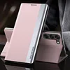 A pink phone case with a silver accent is displayed on a dark surface, with another phone in a similar case visible in the background. Produktbild-Vorschau