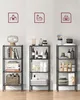 Three tall, narrow shelves are displayed side-by-side against a white wall. Each shelf unit has a different theme indicated by icons above them: office, bathroom, and kitchen. The shelves are filled with various items. Produktbild-Vorschau