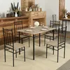 A dining set with a table and four chairs is arranged in a room with a fireplace and wooden paneling. Náhled obrázku produktu