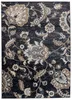 A close-up view of a dark-colored rug with a floral pattern. Náhled obrázku produktu