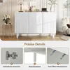 A white sideboard with decorative arches on the doors, shown in a room setting with a side table and flowers. Below the main image are three close-up shots highlighting product features. Voir les images du produit