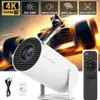 A white projector with a remote control and accessories, set against a background image of a race car. Produktbild-Vorschau
