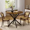 A round dining table with two chairs in a room with a window and curtains. Produktbild-Vorschau