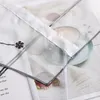 A close-up view of a transparent curtain with a printed image of a coffee cup and a knitted blanket. Produktbild-Vorschau