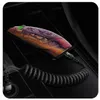 A smartphone is charging wirelessly in a car's center console, connected to a coiled USB-C cable plugged into a car charger. Anteprima dell’immagine prodotto