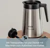 A stainless steel coffee carafe with a black lid and handle, shown with its transport lid and mixing tube. The product is placed on a wooden surface against a light gray background. Podgląd zdjęcia produktu