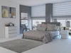 A bedroom with a bed, dresser, and nightstand. Voir les images du produit