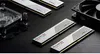A collection of computer hardware components, including RAM modules, a water cooling block, and a fan, arranged on a textured black surface. Podgląd zdjęcia produktu