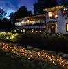 A house decorated with Christmas lights at night. Produktbild-Vorschau