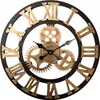 A close-up view of a large, decorative wall clock with Roman numerals and visible gears. Produktbild-Vorschau