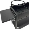 A close-up, angled view of a black metal grill with a side shelf extended. Produktbild-Vorschau