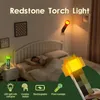 A bedroom scene with a person sleeping in bed, and a redstone torch light mounted on the wall and another one on a nightstand. Náhled obrázku produktu