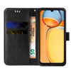A black flip cover phone case with floral and butterfly embossed details, shown open to reveal card slots and a banknote. Produktbild-Vorschau