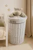 A nursery or child's room setting with a laundry basket, a stuffed animal, and a crib. Produktbild-Vorschau