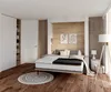 A bedroom scene with a bed, nightstand, lamp, and closet. Produktbild-Vorschau
