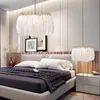 A bedroom scene with a bed, nightstand, and two feather lamps. Podgląd zdjęcia produktu