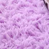 A close-up view of a fluffy, shaggy rug in a light purple color. Náhled obrázku produktu