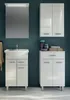A bathroom vanity set with a sink and cabinets against a dark teal wall. Voir les images du produit