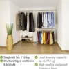 A corner of a room with a clothing rack system holding various garments and a shoe rack with shoes. Produktbild-Vorschau
