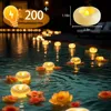 Floating LED candles in a swimming pool at night. Produktbild-Vorschau