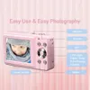 A pink digital camera is shown with a child's face on its screen, and labels pointing to its buttons and features. Produktbild-Vorschau