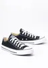 A pair of black Converse All Star low-top sneakers with white laces and soles, shown on a white background. Voir les images du produit