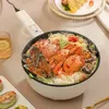 Weißer elektrischer Kochtopf gefüllt mit gedämpftem Meeresfrüchte-Nudelgericht, mit Krabben, Miesmuscheln und Garnelen Produktbild-Vorschau