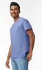 A man wearing a blue t-shirt and jeans, posing for a product shot. Produktbild-Vorschau