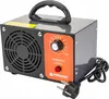 A close-up studio shot of a gray and orange ozone generator with a black handle and power cord.