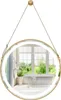 A round bathroom mirror with LED lighting, suspended by a strap, reflecting a bathroom interior with a bathtub and window. Anteprima dell’immagine prodotto