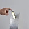 A hand is shown touching a modern LED table lamp with a silver finish. Produktbild-Vorschau