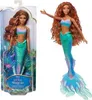 A doll in its packaging and a separate image of the doll. Voir les images du produit