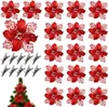 A collection of red artificial poinsettia flowers and silver clips arranged on a white background, with a small section of a Christmas tree visible at the bottom. Produktbild-Vorschau