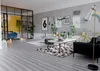 A modern living room with a bedroom area separated by glass doors. The room features a sofa, coffee table, rug, and decorative items. Produktbild-Vorschau