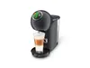 A dark gray Krups Dolce Gusto capsule coffee machine is shown on a white background, with a glass of latte macchiato being dispensed. Voir les images du produit